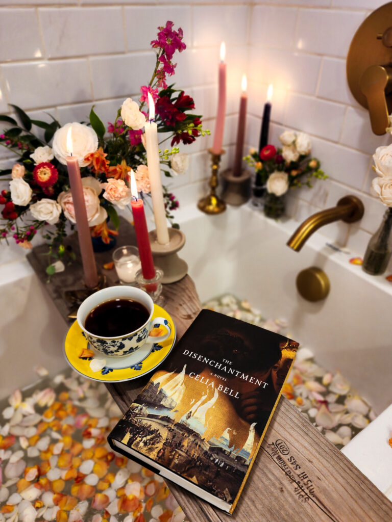 Cover of The Disenchantment by Celia Bell in a candlelit and petal filled bath.